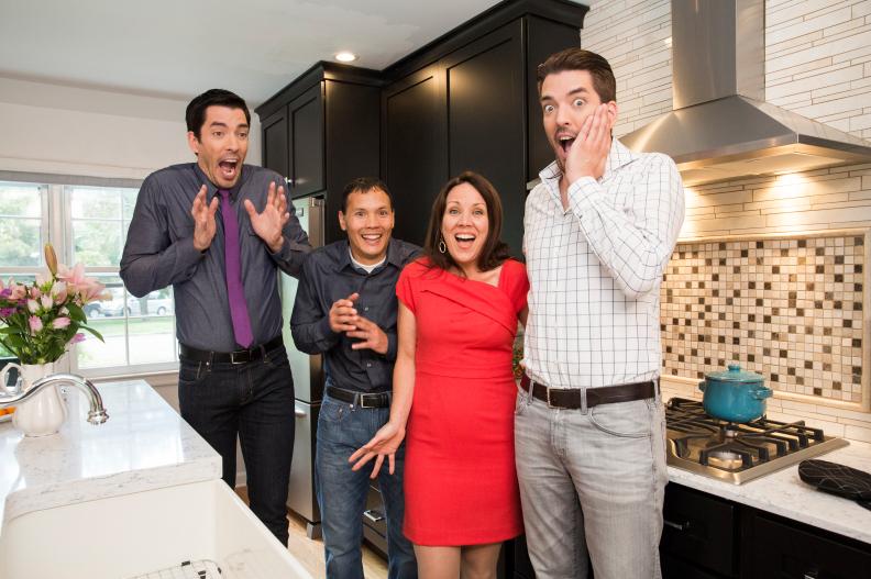 Hosts Drew (L) and Jonathan Scott (R) pose for a portrait in the newly-remodeled master kitchen of Tom (center L) and Brdiget Suvansri's (center R) home in Stamford, Connecticut, as seen on Property Brothers. (portrait)