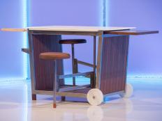Designer Miles Endo's design, a steel frame and wood sided multi-functional kitchen table-island-cart with pull out stools is presented on judging day, as seen on Ellen's Design Challenge. This week the designers had to create a multi-functional piece of furniture inspired by a bench-table on which they sat during the challenge reveal without knowing that it was multi-functional. Ellen DeGeneres puts eight furniture designers to the test when they come to Los Angeles to compete in various challenges designing and building amazing furniture creations. With a workshop, a lead carpenter and all the tools they’ll need, the contestants will be tasked with a new build each episode. A panel of expert judges along with appearances by Ellen will eliminate them one by one until one designer is left standing to take home the cash prize and win “Ellen’s Design Challenge.”