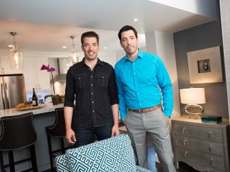 Hosts Jonathan (L) and Drew (R) Scott pose for a portrait in the living room of Beeban Natt and Sukhvir Dhamrhat's new home in Rye Brook, New York, as seen on Property Brothers. (Portrait)