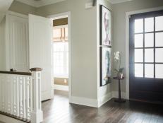 With an eye-catching color scheme and a cozy, accessible powder room, the foyer establishes the home's unique, high-design approach.