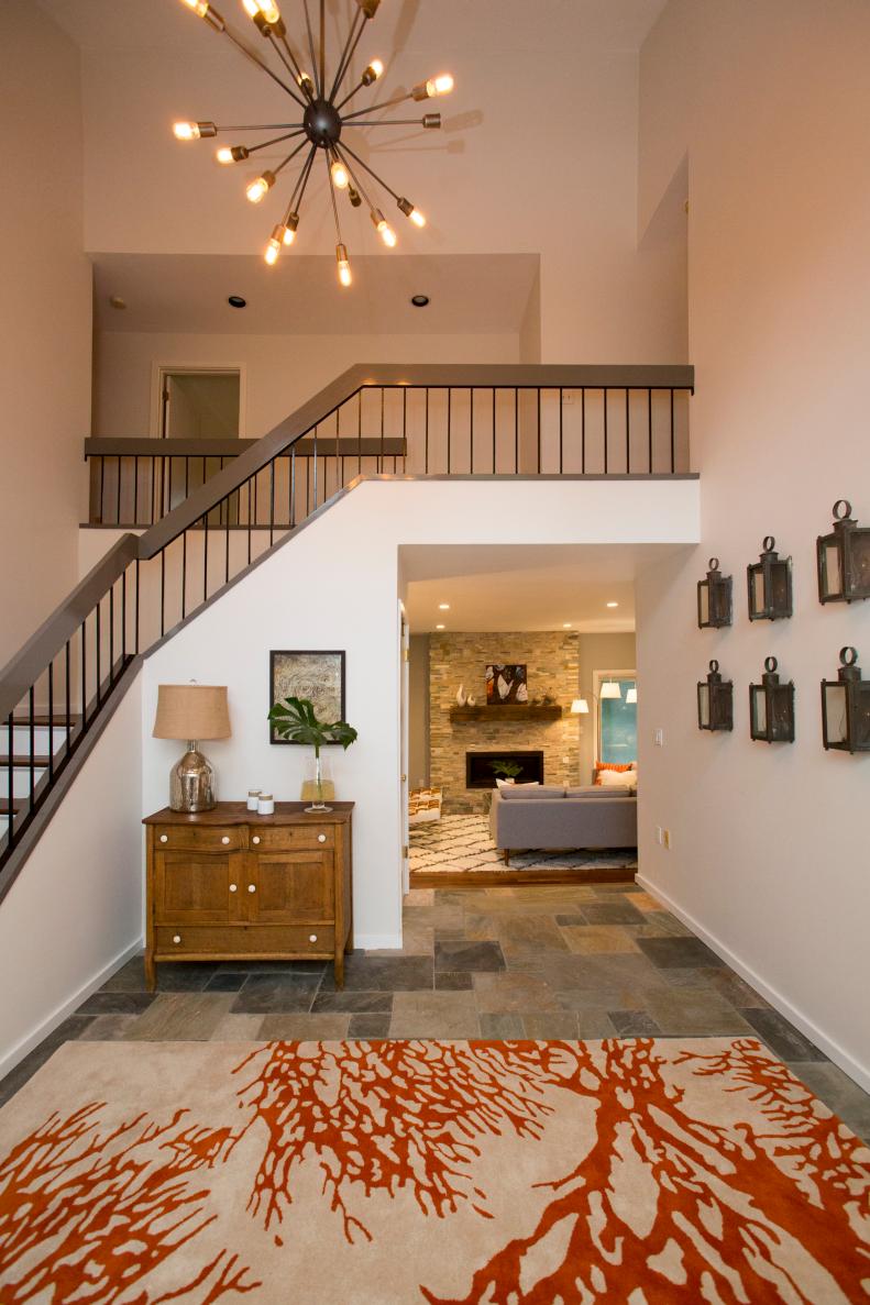 Entryway - After 1: After the renovation, the entryway of Suzanne and Kevin Vining's new home in Pound Ridge, New York, has a slate-tiled floor and feels bright and welcoming with high ceilings and industrial/vintage furniture and accessories, as seen on Property Brothers. (After)