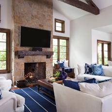 White Great Room Features Dark Wood Trim, Stylish Blue Accents