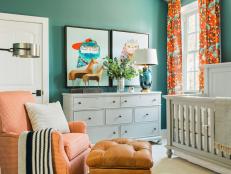 Playful patterns and kid-approved artwork give this teal and orange, gender-neutral nursery a cozy, modern aesthetic.
