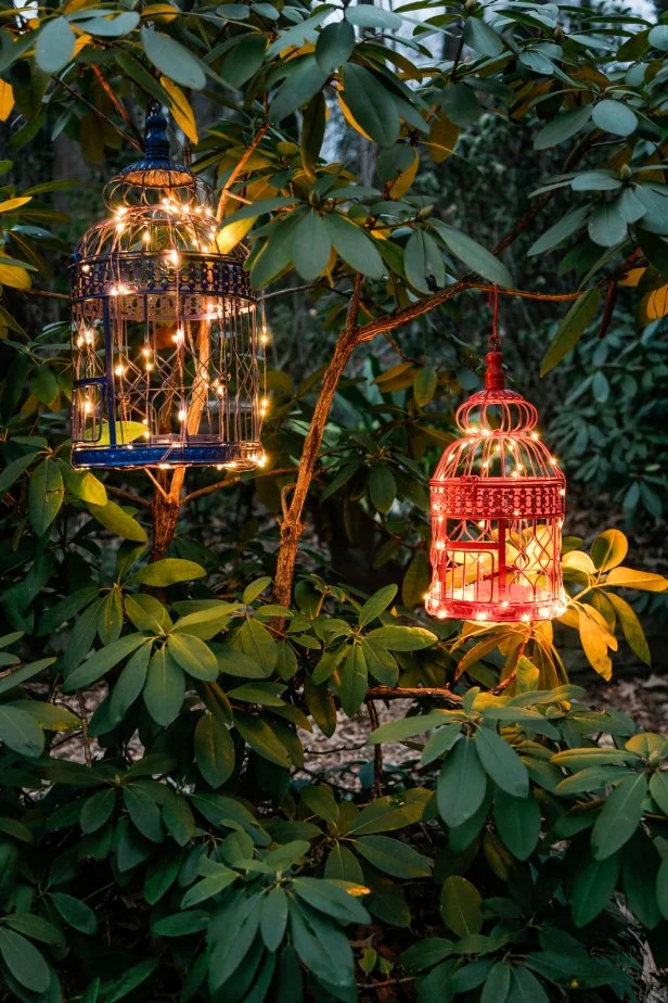 Give your deck or patio a welcoming, exotic vibe with these DIY birdcage lanterns painted in vibrant hues and outfitted with convenient remote controlled LED lights.