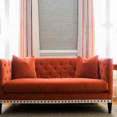 Orange Tufted Sofa and Lamps