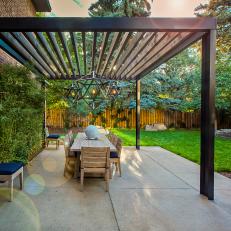 Modern Steel Beam Pergola with Hanging Light Pendants and Dining Table