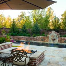 Outdoor Patio Seating with Fire Pit Beside Rectangle Pool