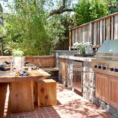 Built-In Bench and Table Next to Outdoor Kitchen