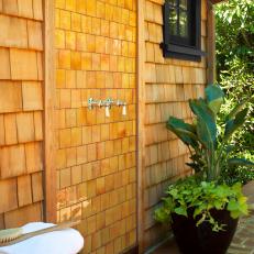 Outdoor Shower Against Wood-Paneled Wall