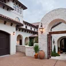 Spanish-Style Home with Arched Stone Entry Gate