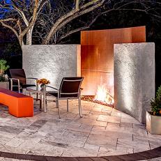 Modern Style Outdoor Fireplace in Circular Paver Seating Area