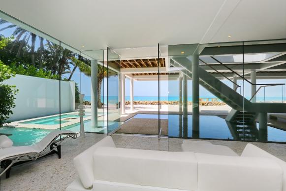 White Sofa in Room with Glass Walls and Ocean View