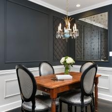 Black and White Dining Area with Mirror and Chandelier