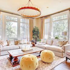 Round Chandelier, Ottomans Draw Attention in Living Room