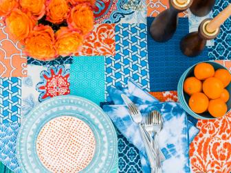 PLAYFUL TABLETOPSAdd a high-energy look to your outdoor dining space in a family-friendly manner with a DIY tablecloth made from fabric scraps. Choose 5 to 7 different fabrics in similar colors ranging in styles form solids and stripes to botanicals and geometrics. The key to creating this look, without it becoming too busy, is to vary the scale of each pattern. For best results, pick up a white or off-white, ready-made table cloth, lay your scraps out patchwork style, and then bond them to the tablecloth by hand stitching each scrap, or bonding them in place with fabric glue.