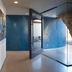 Hallway With Blue Accent Wall and Art
