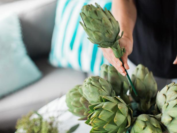Continue adding artichokes until you have a fairly tight arrangement. HINT: Soak your floral foam in water for a few minutes before you start this process.