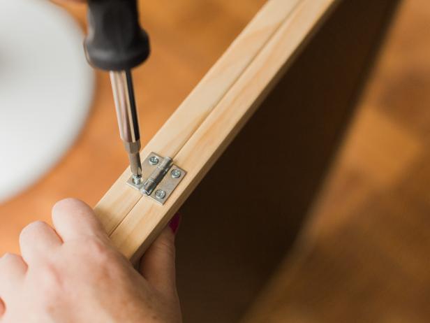 Using a drill or phillips head screw driver, attach the hinges with the supplied hardware.