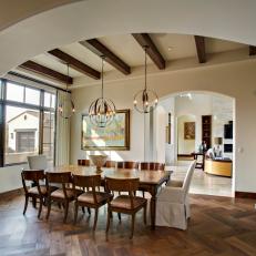Mediterranean Dining Room With Exposed Beam Ceilings and Large Archways