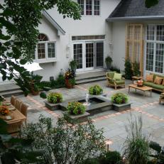 Stone Patio With Fountain and Teak Furniture
