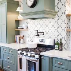 Country Kitchen With Tile Decorative Backsplash, Green Cabinets and Floating Shelf Storage 