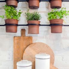 Black Metal Mounts and Ceramic Pots for Indoor Herb Garden in Bright, White Kitchen 