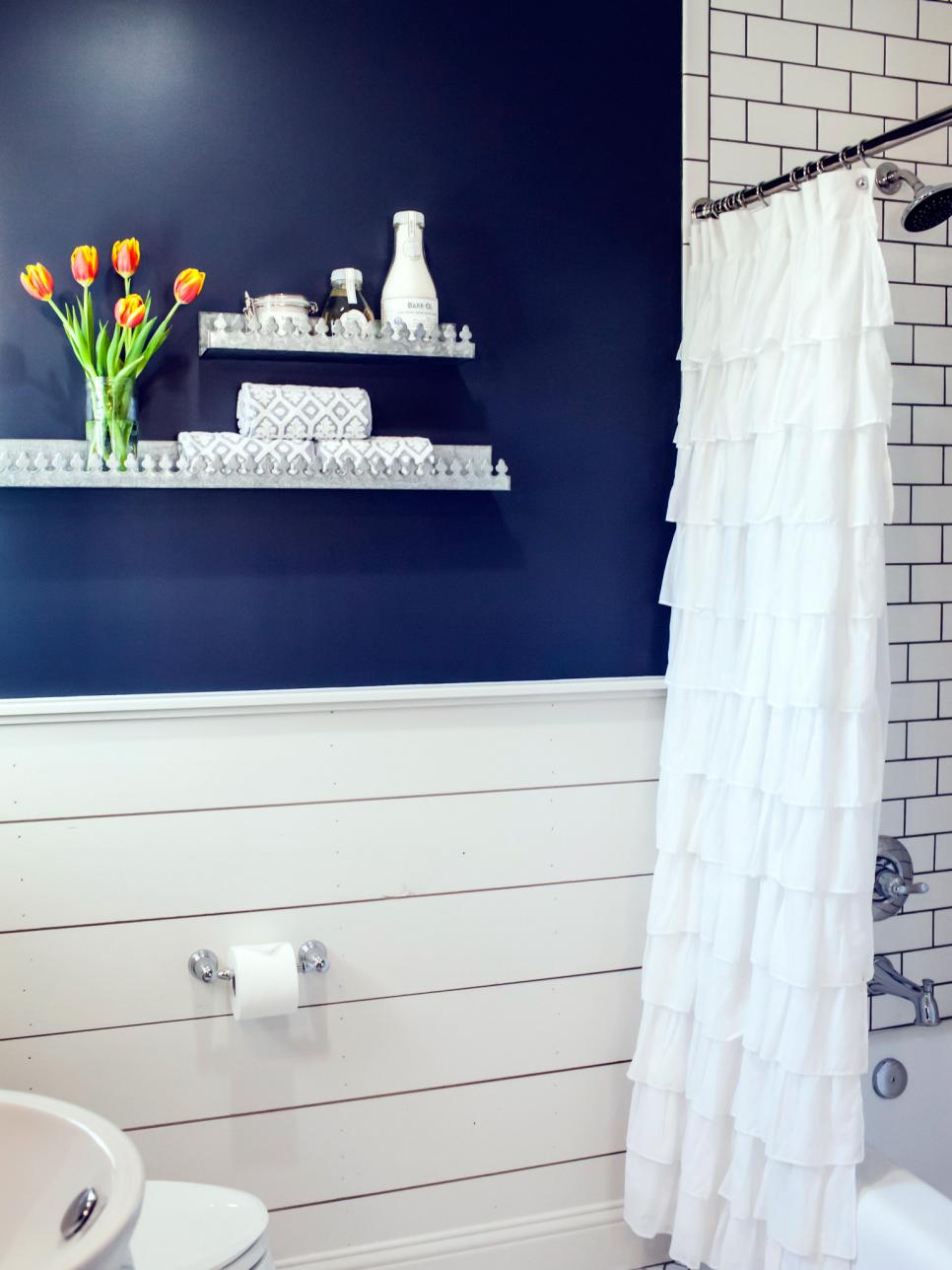 Bright Country Bathroom With Navy Accent Wall, White Subway Tile Shower