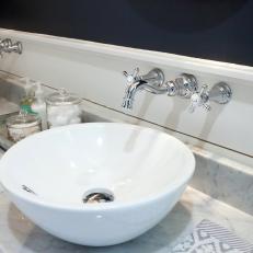 Contemporary Bathroom Vanity With Matching White Vessel Sinks, Marble Countertop and Navy Blue Accent Wall 