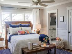 Gorgeous Country Wood Headboard, Royal Blue Bed Accents and Large Area Rug in Neutral Bedroom 