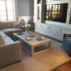 Classy Transitional Living Room With Large Built In Entertainment Center, Tan Sectional and Painted Wood Coffee Table 
