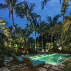Tropical Garden Oasis and Pool at Night