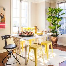 Eclectic Dining Room With Yellow Stools