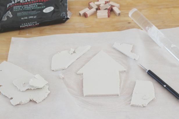 Step 2: Use knife to cut out a shape of a house. Step 3: Smooth the edges with your fingers.