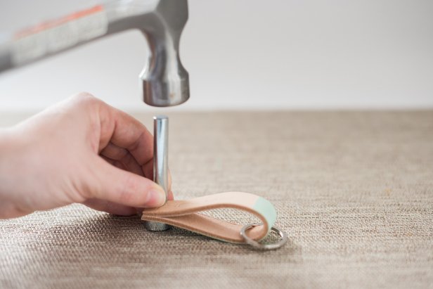 Step 6: Fold the leather in half. Step 7: Thread on the key ring. Step 8: Attach both ends of the leather to each other with a metal rivet. Follow the instructions that came with your rivets.