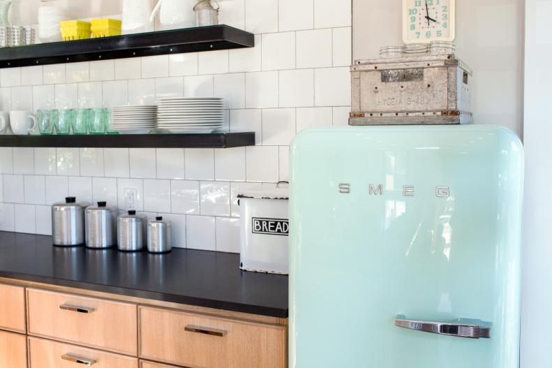 Blue Vintage Refrigerator in Kitchen with White Tile and Black Shelves