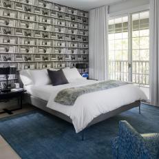 Modern Bedroom With Black and White Bookshelf Wallpaper, Blue Area Rug and White Bed Linens  