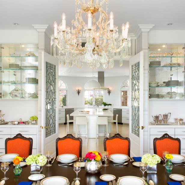 Modern Kitchen With Elegant Globe Chandeliers lavish transitional dining room with crystal chandelier orange dining chairs and glass china shelving