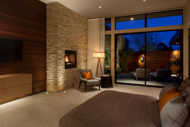 Modern Master Bedroom With Textured Brick Fireplace Surround