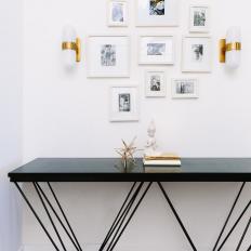 Eclectic Space With Black Table and Photography