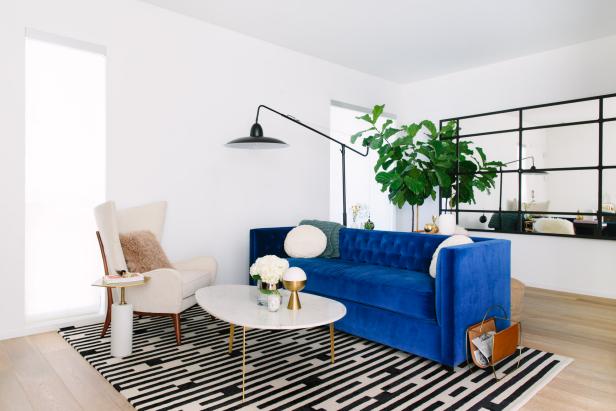 Black and White Rug and Bright Blue Sofa in Eclectic Living Room