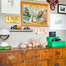Old License Plates and Outdoorsy Art Blend Well with a Modern Campaign Chest of Drawers