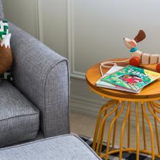 A Modern Basket-Style Side Table Adds Unique Color in a Nursery