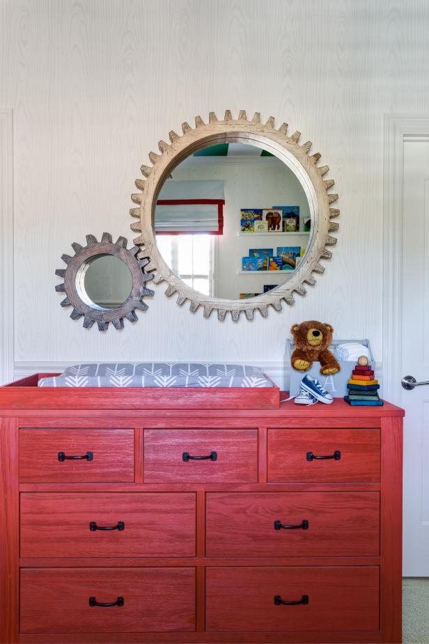 Wood Gear Mirrors Adorn The Wall Above A Red Stained Dresser And