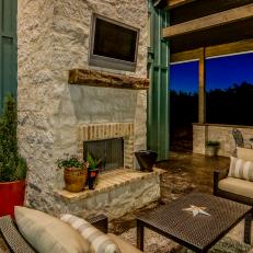 Back Porch With Limestone Fireplace And Wicker Furniture