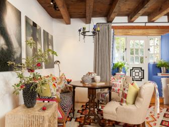 Multicolored Sitting Room With Exposed Beam Ceiling and Blue Foyer