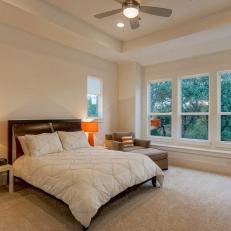 Modern Neutral Bedroom With Orange Bedside Lamps