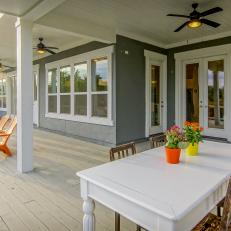 Spacious Covered Porch With Outdoor Dining Table and Chairs