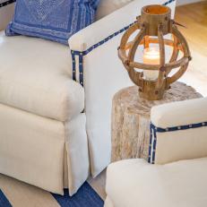 White Armchair With Blue Throw Pillow