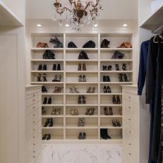 Stylish Walk In Closet With Marble Flooring, Traditional Chandelier and Built In Shoe Shelving 