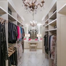 Transitional Walk In Closet With Traditional Chandeliers, Built in Hanging Racks and Shelving and White Marble Floor